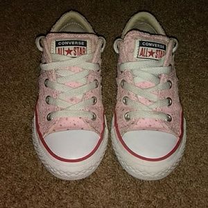 Little girl pink Converse shoes.